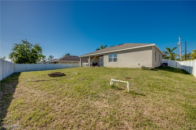 rear view of property with a lawn