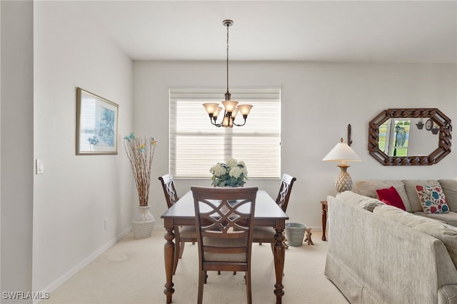 carpeted dining room featuring an inviting chandelier