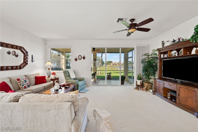 carpeted living room featuring ceiling fan