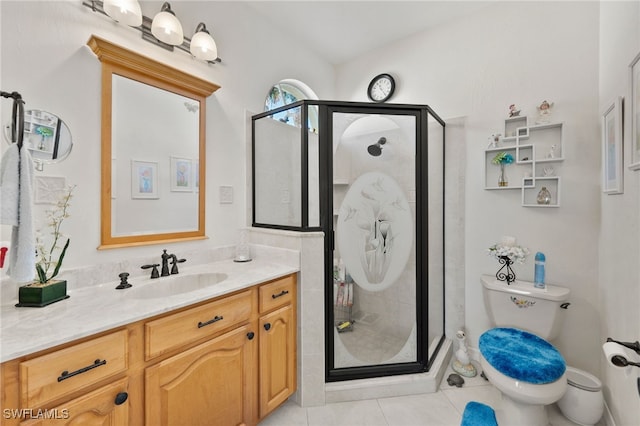 bathroom featuring tile patterned flooring, vanity, toilet, and an enclosed shower