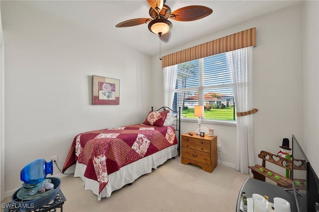 bedroom featuring light colored carpet and ceiling fan