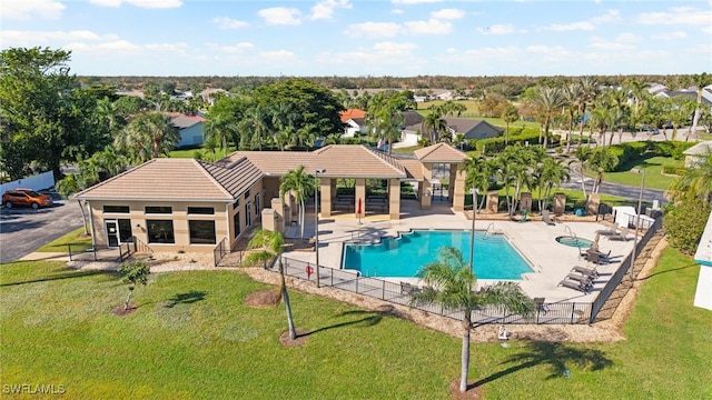 view of swimming pool featuring a patio area and a lawn