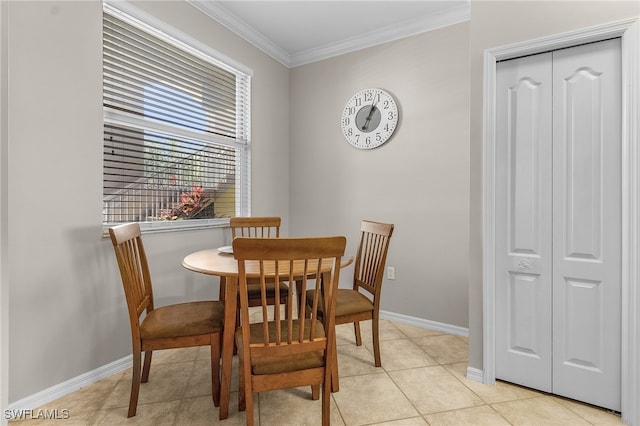 tiled dining area featuring crown molding