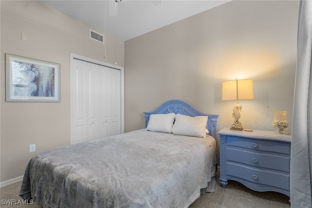 carpeted bedroom with ceiling fan and a closet