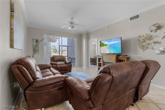 living room with a fireplace, ceiling fan, ornamental molding, and light tile patterned flooring