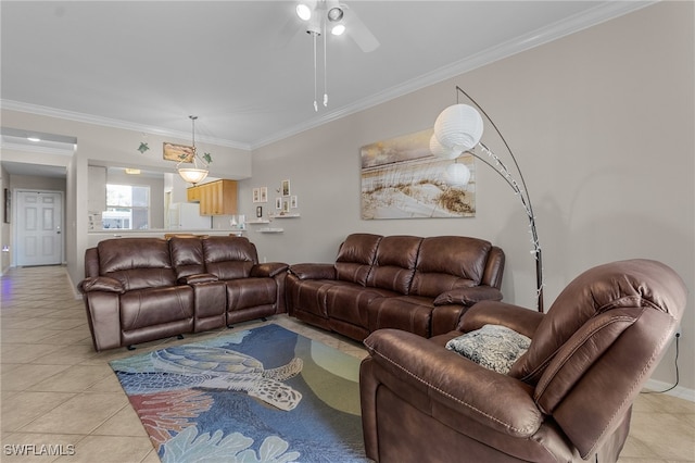 living room featuring ceiling fan, ornamental molding, and light tile patterned floors