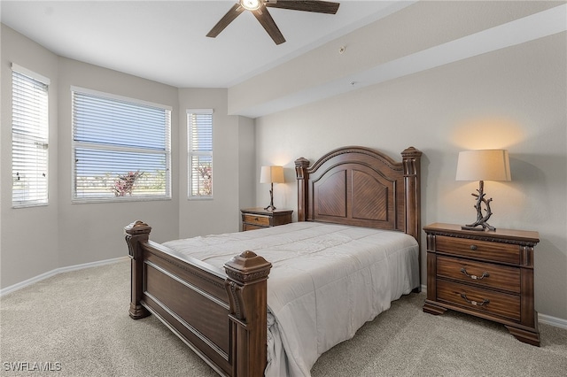 bedroom with ceiling fan and light colored carpet