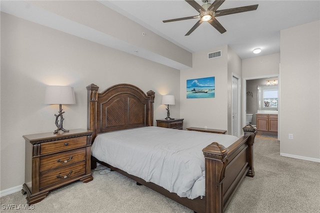 bedroom with connected bathroom, ceiling fan, a closet, and light carpet