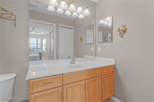 bathroom with vanity, toilet, and ceiling fan