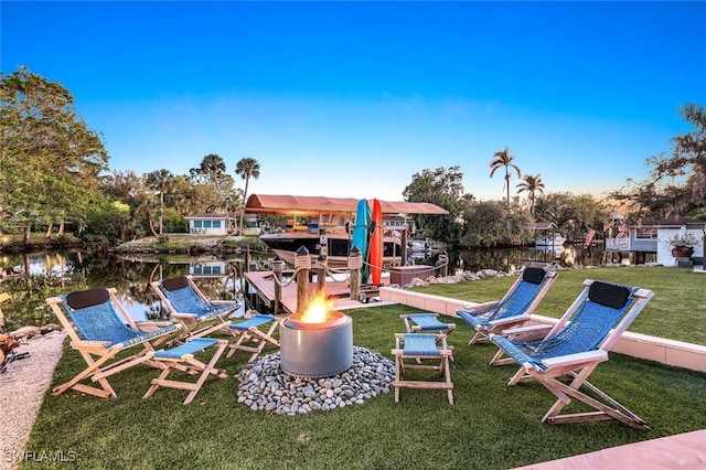 view of play area featuring a lawn and a water view