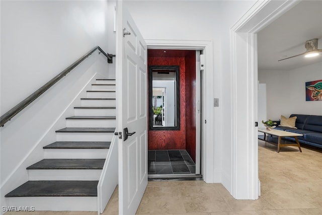 staircase with ceiling fan