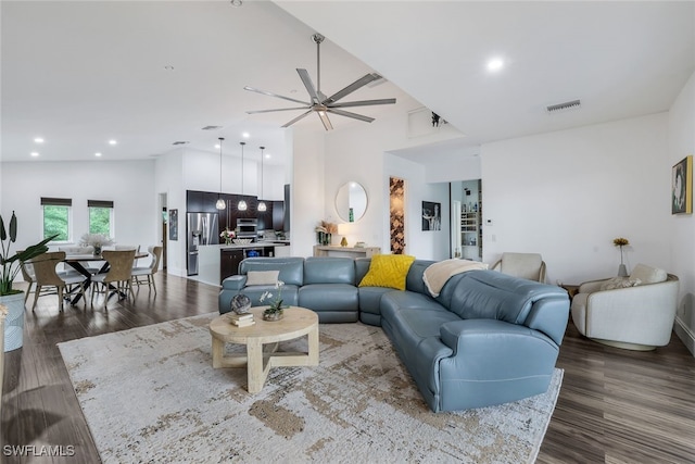 living room with hardwood / wood-style flooring, high vaulted ceiling, and ceiling fan