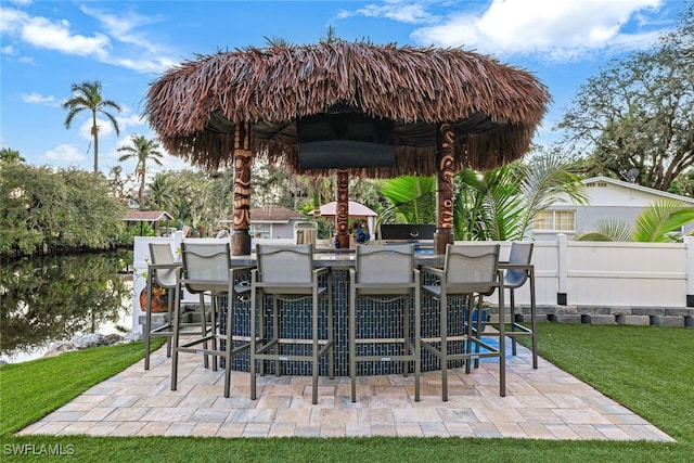 view of patio / terrace featuring an outdoor bar and a grill