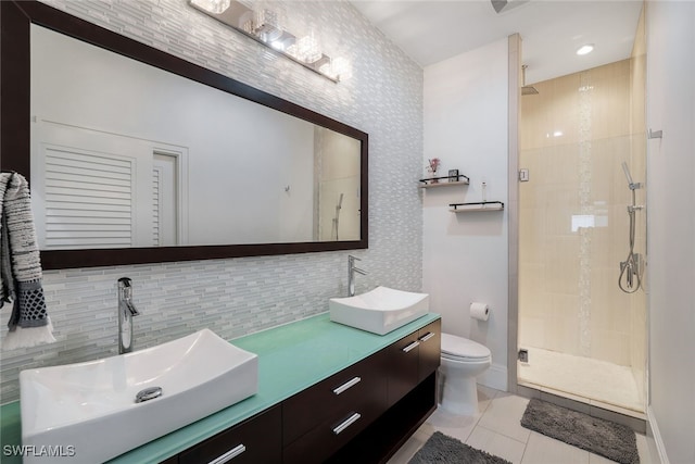 bathroom featuring decorative backsplash, tile patterned floors, walk in shower, vanity, and toilet