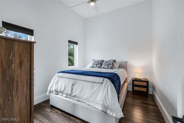 bedroom featuring dark hardwood / wood-style floors, ceiling fan, and lofted ceiling