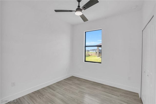 empty room featuring ceiling fan and light hardwood / wood-style floors