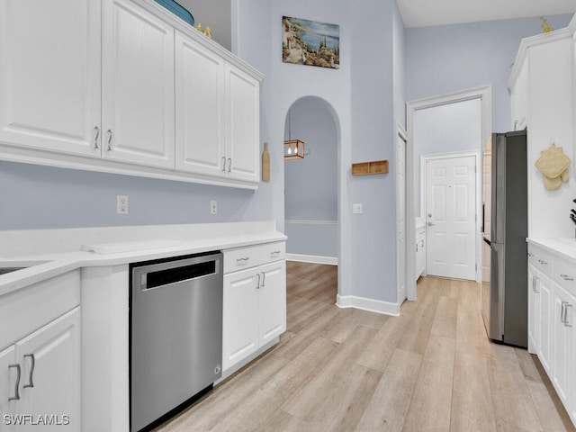 kitchen featuring white cabinets, light wood-type flooring, and appliances with stainless steel finishes