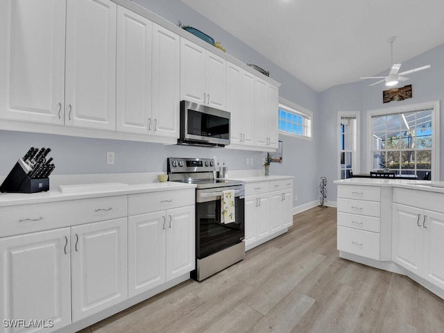 kitchen featuring white cabinetry, light hardwood / wood-style flooring, ceiling fan, and appliances with stainless steel finishes