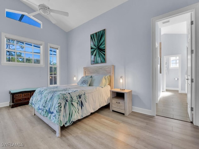 bedroom featuring high vaulted ceiling, light hardwood / wood-style flooring, and ceiling fan