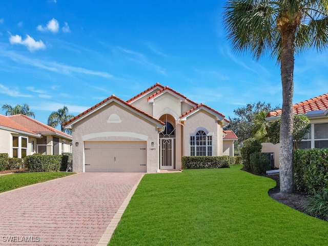 mediterranean / spanish-style home featuring a front lawn and a garage