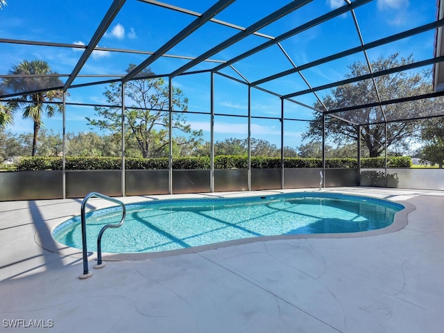 view of swimming pool featuring a lanai, a patio, and a water view