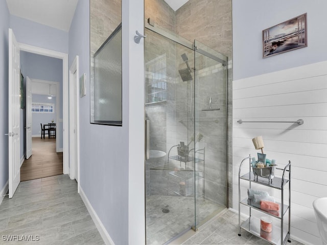 bathroom featuring wood-type flooring and an enclosed shower