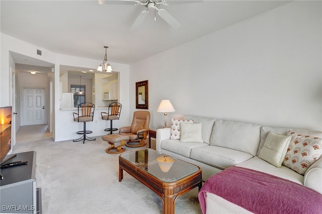 living room with ceiling fan and carpet floors