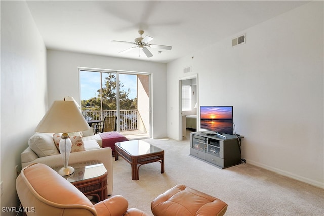 living room featuring light carpet and ceiling fan