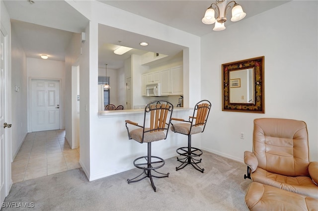 living area with light carpet and a chandelier