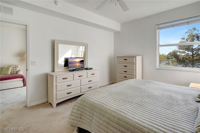 bedroom with ceiling fan and light carpet