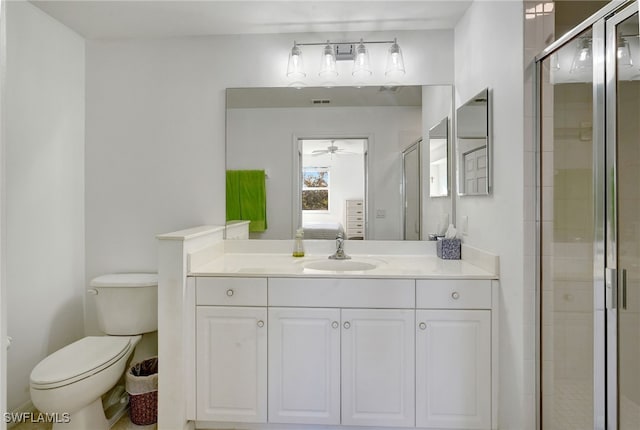 bathroom featuring walk in shower, ceiling fan, vanity, and toilet