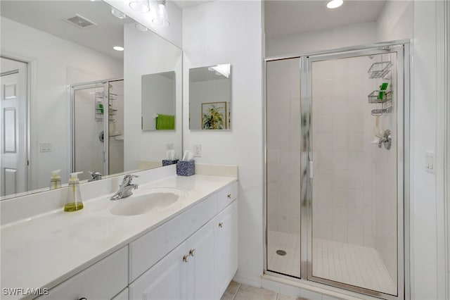 bathroom featuring vanity, tile patterned floors, and walk in shower