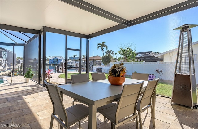 view of patio featuring glass enclosure