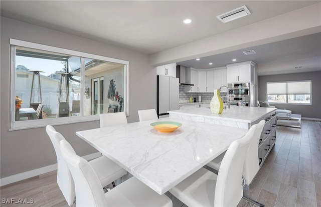 dining area with light hardwood / wood-style floors