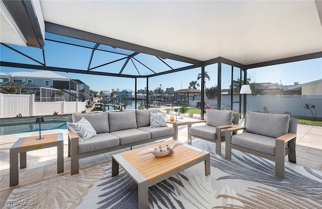 view of patio featuring an outdoor hangout area, a lanai, a fenced in pool, and a water view