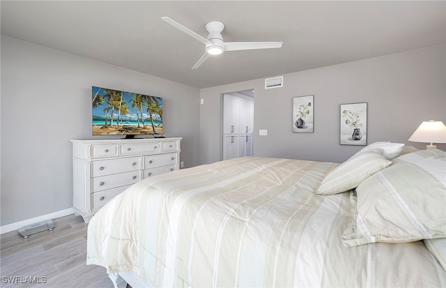 bedroom with ceiling fan and light hardwood / wood-style floors