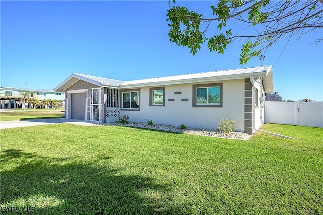 view of front facade with a front yard and a garage