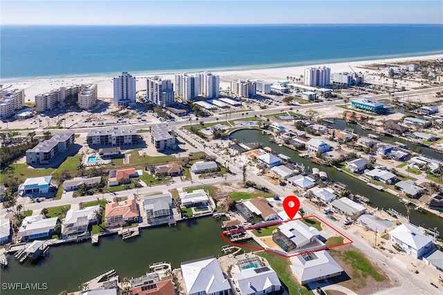 birds eye view of property featuring a water view and a view of the beach