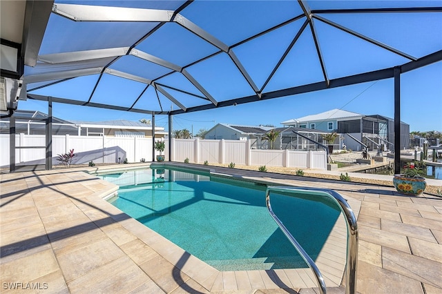 view of pool featuring glass enclosure and a patio