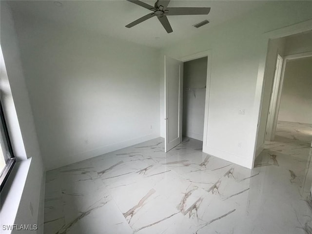 unfurnished bedroom featuring ceiling fan and a closet