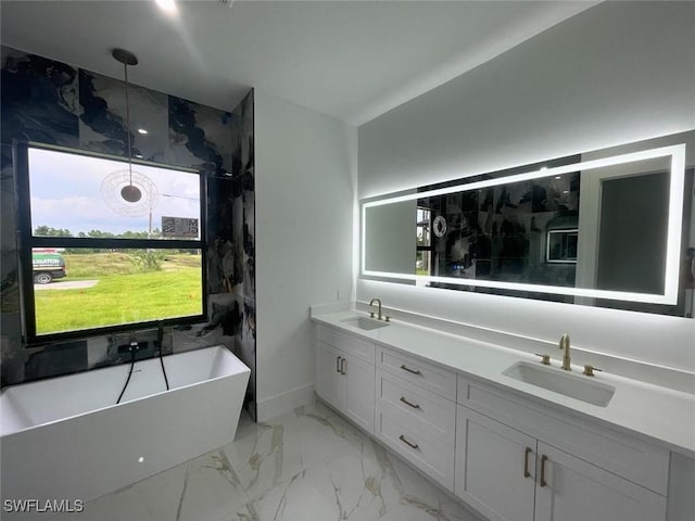 bathroom featuring a washtub and vanity