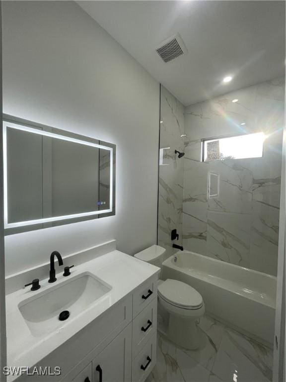 full bathroom with vanity, tiled shower / bath combo, and toilet