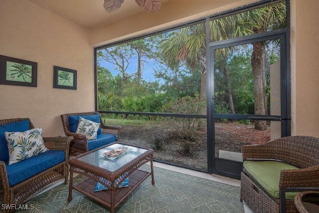 sunroom / solarium featuring ceiling fan