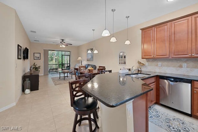 kitchen with ceiling fan, stainless steel dishwasher, kitchen peninsula, and sink