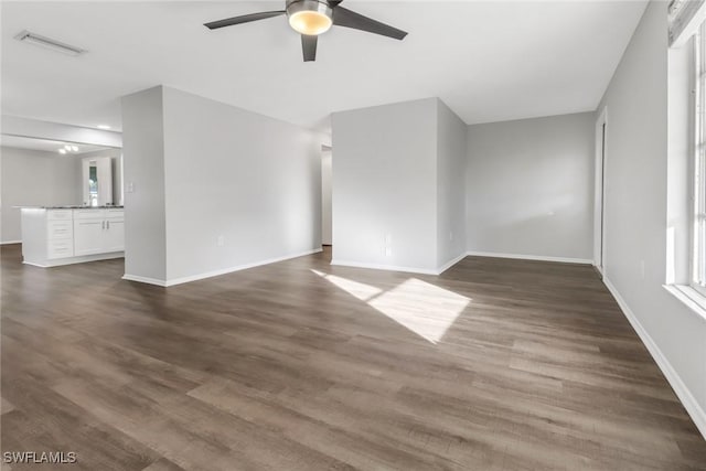 interior space with dark hardwood / wood-style flooring, a healthy amount of sunlight, and ceiling fan