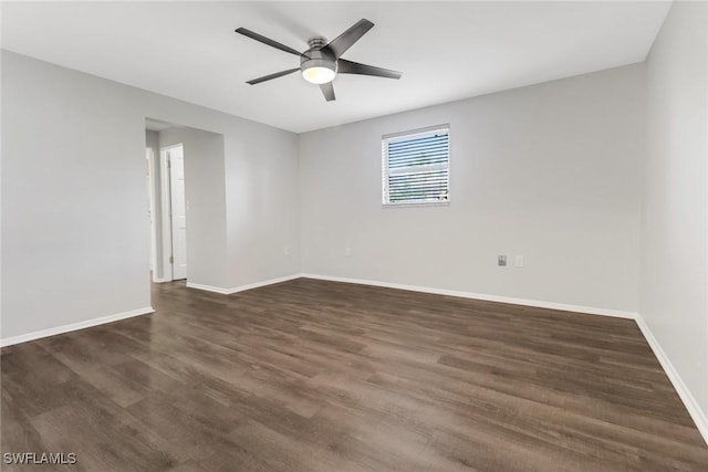 spare room featuring ceiling fan and dark hardwood / wood-style flooring