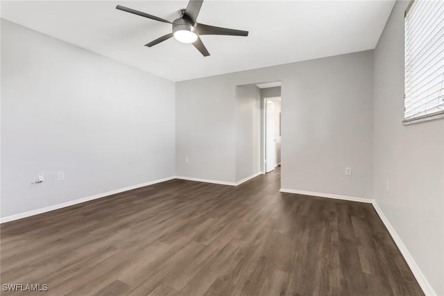 spare room featuring ceiling fan and dark hardwood / wood-style floors