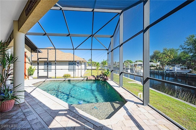 view of pool with a lanai, a water view, a yard, and a patio