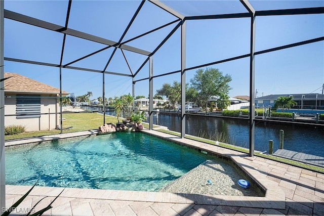 swimming pool with a water view, glass enclosure, and a patio