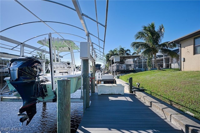 dock area featuring a lawn and a water view